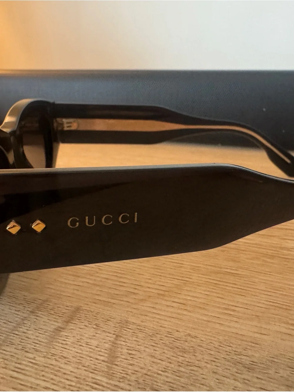 Gucci Glossy Black Oval Sunglasses with Dark Lenses